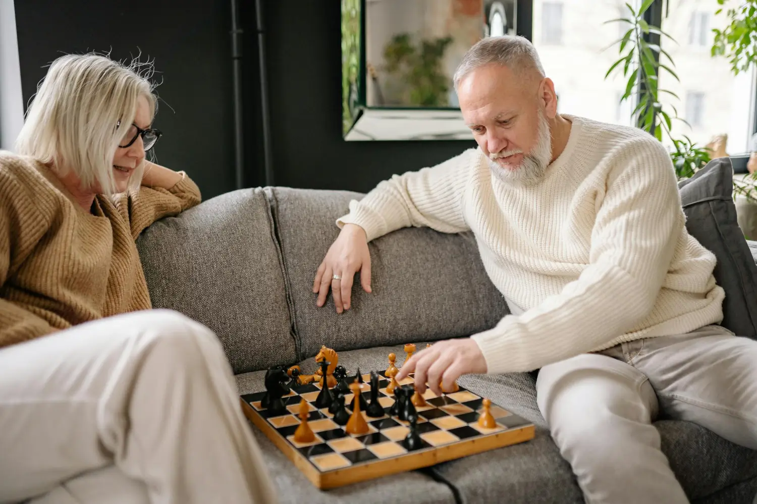 Elderly couple playing chess to stimulate their brain